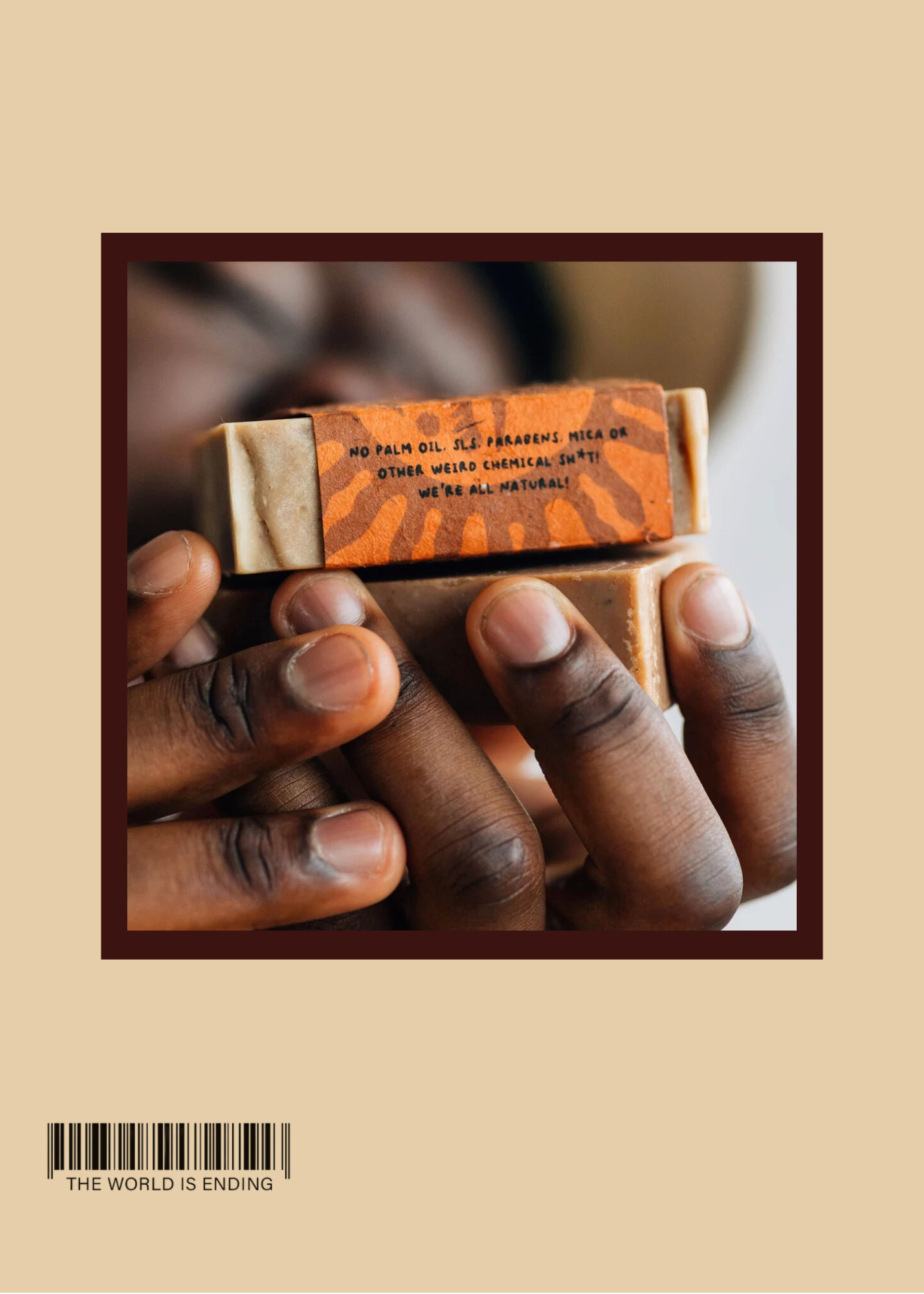 Close-up of hands holding two bars of soap with artistic packaging.