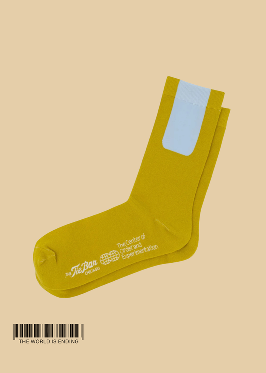 THE CENTER OF ORDER AND EXPERIMENTATION x THE TIE BAR THE INDEX OCHRE SOCK