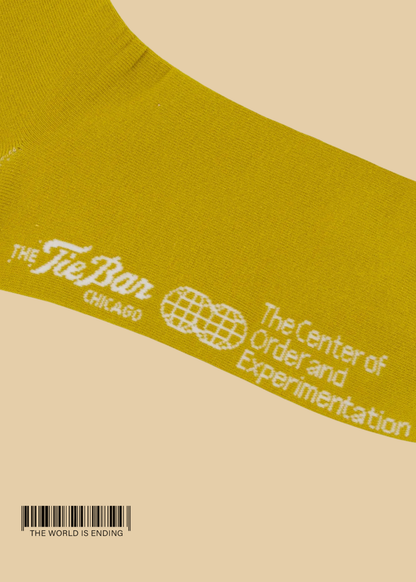 THE CENTER OF ORDER AND EXPERIMENTATION x THE TIE BAR THE INDEX OCHRE SOCK
