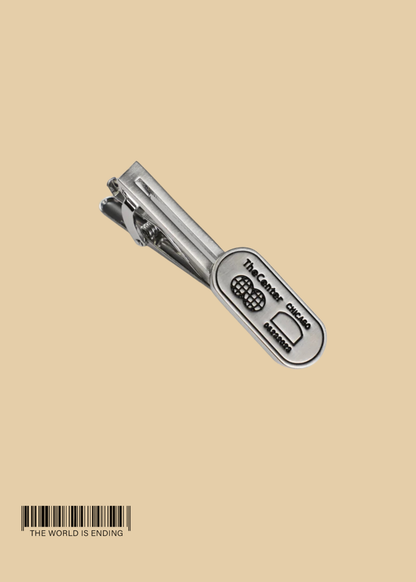 THE CENTER OF ORDER AND EXPERIMENTATION x THE TIE BAR THE INDICATOR BRUSHED SILVER TIE BAR