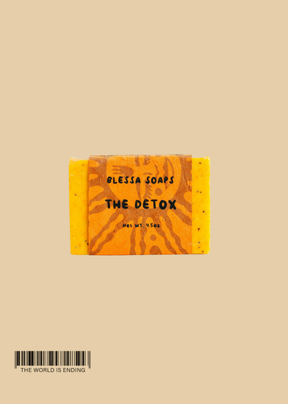 A bar of soap labeled 'THE DETOX' by Blessa Soaps, featuring a vibrant orange color and artistic design.