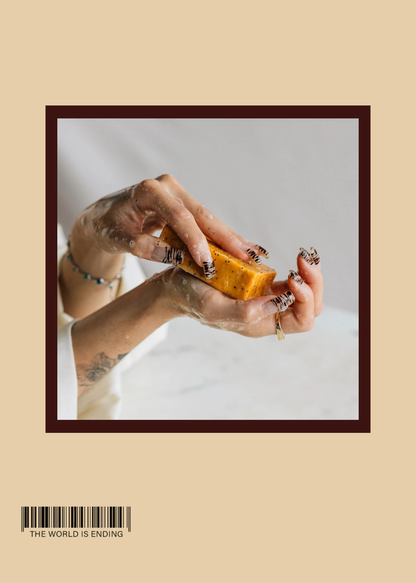 Close-up of hands holding a piece of soap, with artistic nails and water droplets.