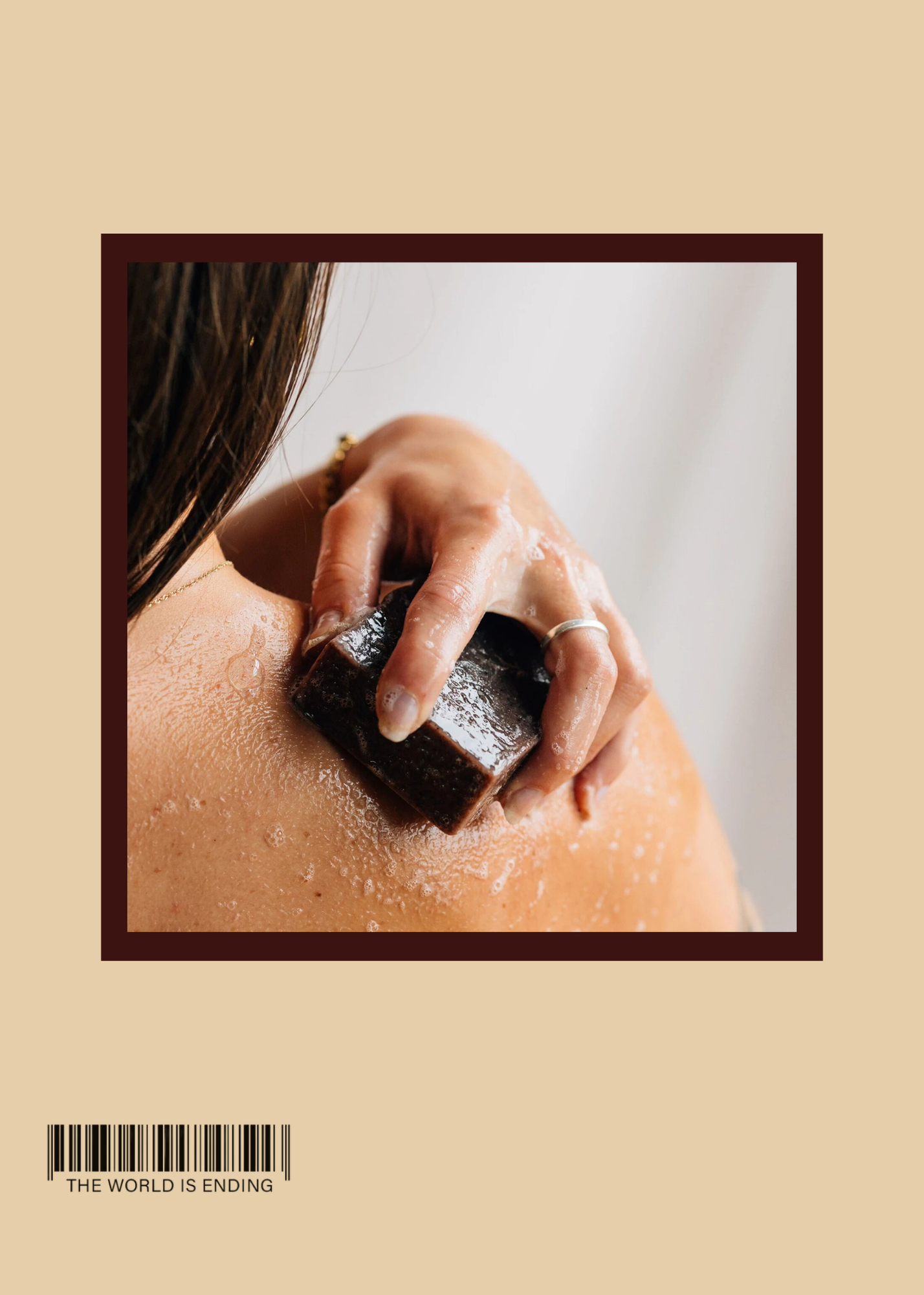 A hand applying soap to the shoulder during a bath or shower.